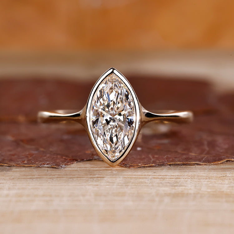 Marquise diamond ring solitaire bezel setting pinch shank.