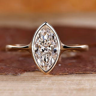 Marquise diamond ring solitaire bezel setting pinch shank.