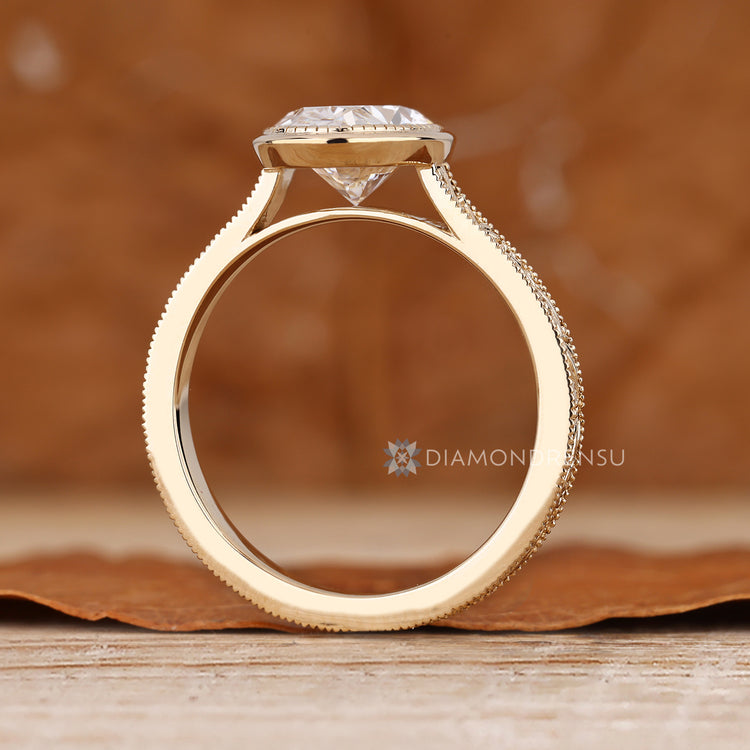 Oval diamond ring with cathedral solitaire style.