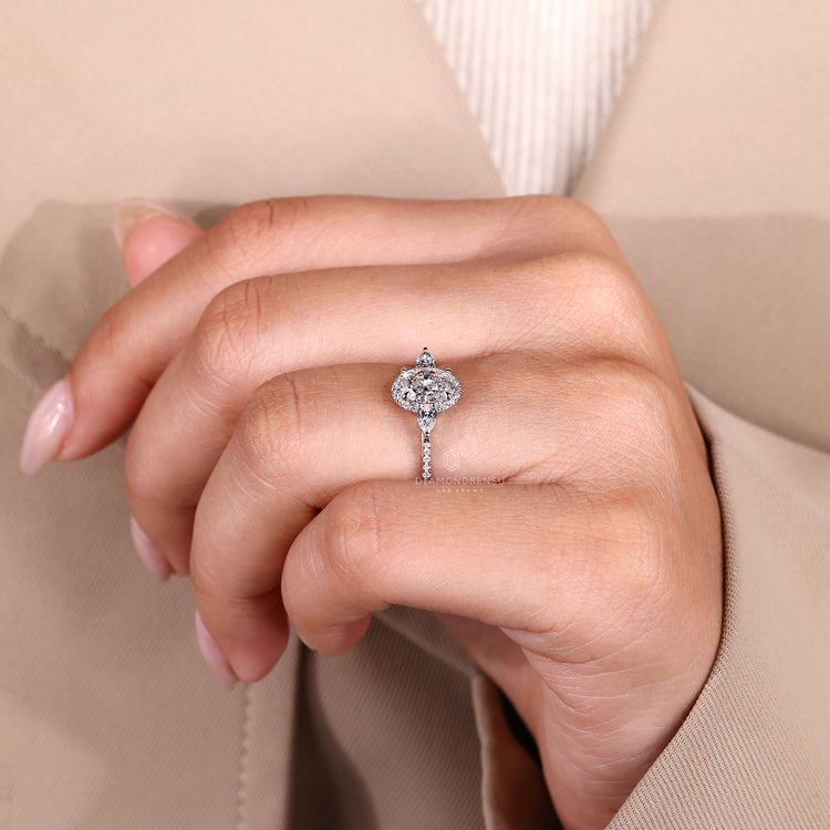 Oval cut diamond ring with four claw prong setting.