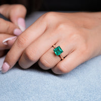 Emerald gemstone ring art deco tapered shank style.