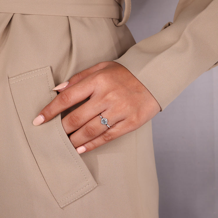Round cut diamond ring four prong halo cluster design.