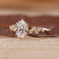 Vintage oval diamond ring round side stones cluster.