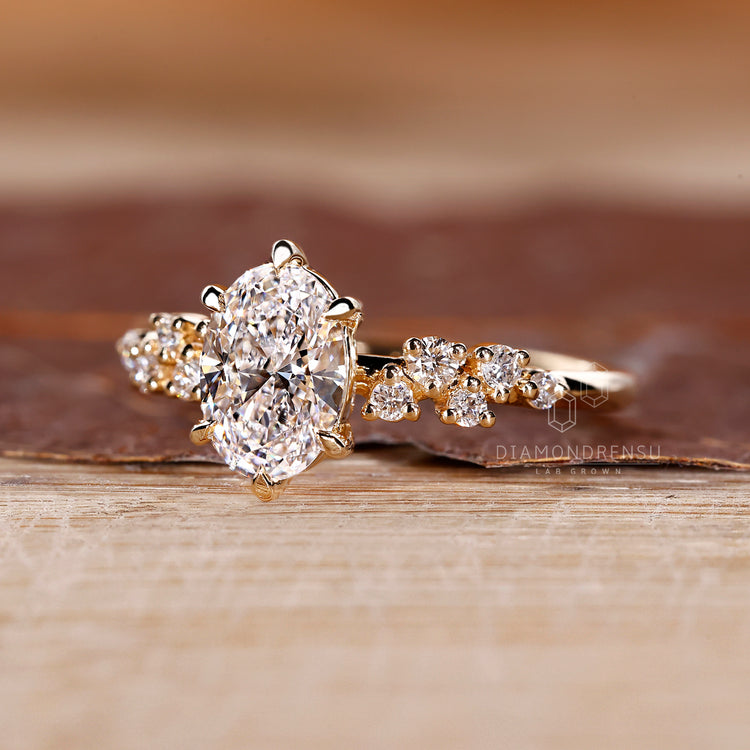 Vintage oval diamond ring round side stones cluster.