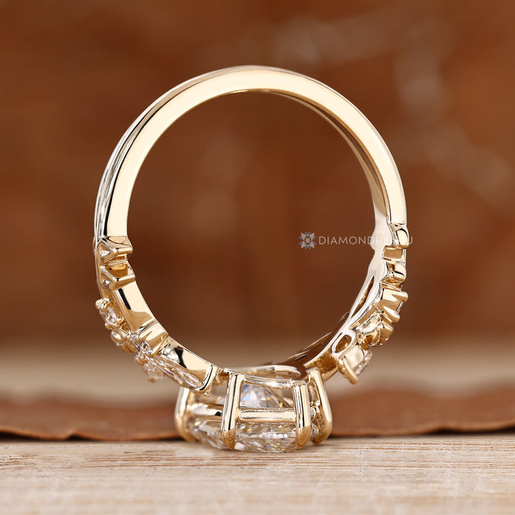 Marquise ring with marquise side stones and claw prongs.
