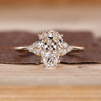 Coffin cut diamond ring round side stones set.