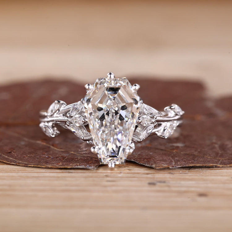 Coffin cut diamond ring marquise side stones set.