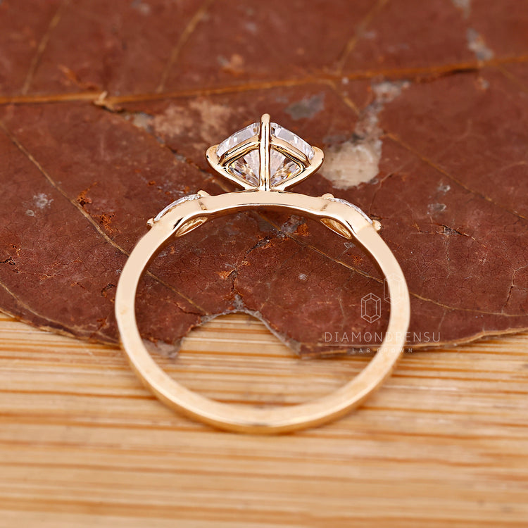 Cushion diamond ring marquise side stones prong set.