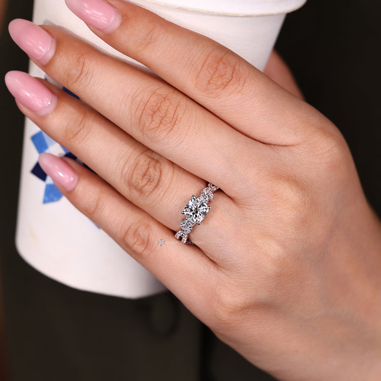 Cushion diamond ring cluster with side stones.