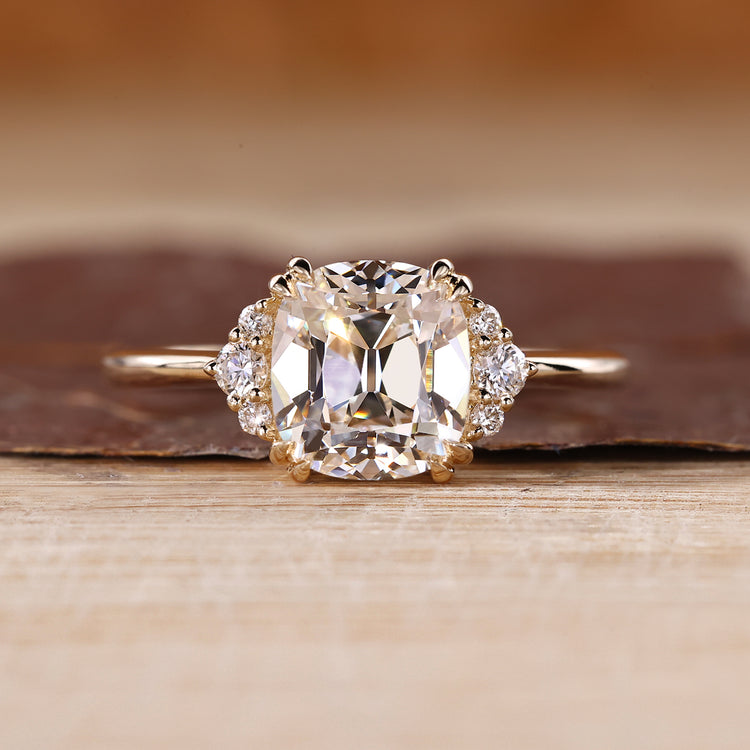 Cushion Old European Cut Ring with round cut side stones.