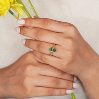 Oval diamond ring with round diamond bridge accent.