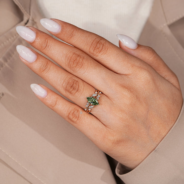 Green diamond ring with marquise side stones.