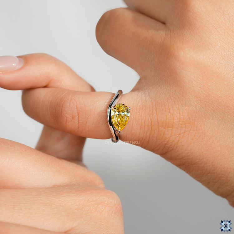 IGI certified pear diamond ring with east to west style.