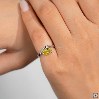 Handmade pear diamond ring with yellow gold curved band.