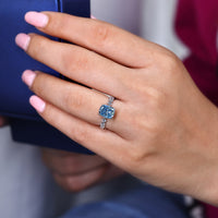 Lab grown cushion cut diamond ring in shared prong setting.