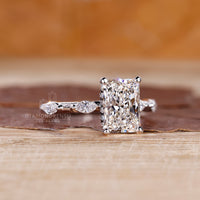 Lab grown radiant cut diamond ring with side stones.