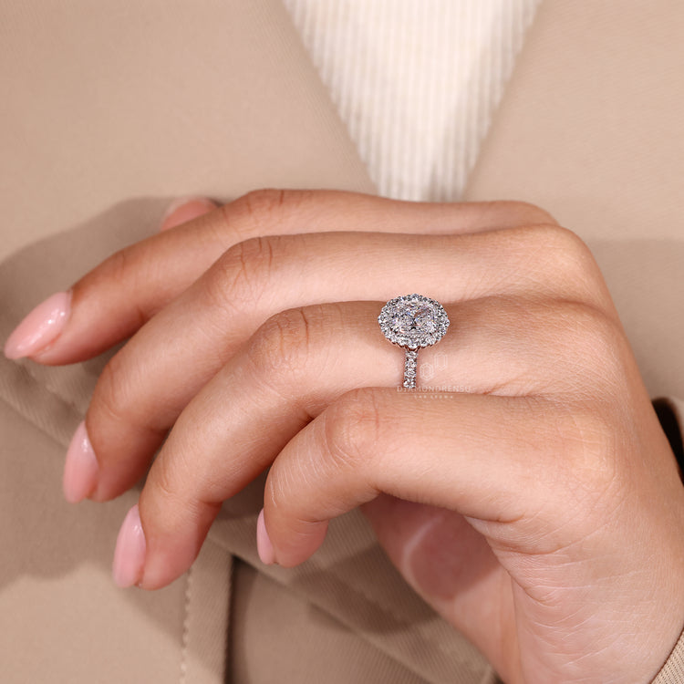 Elongated cushion cut diamond ring with double claw prong setting.