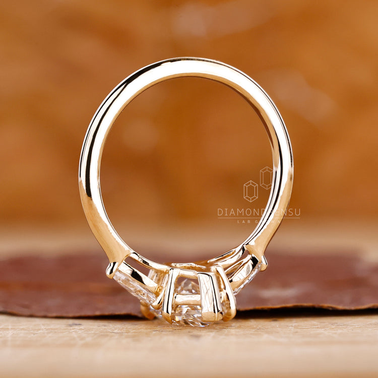 Marquise diamond ring three stone v prong setting.