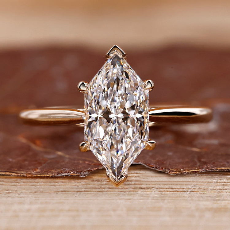 Dutch marquise diamond ring hidden halo v prong set.