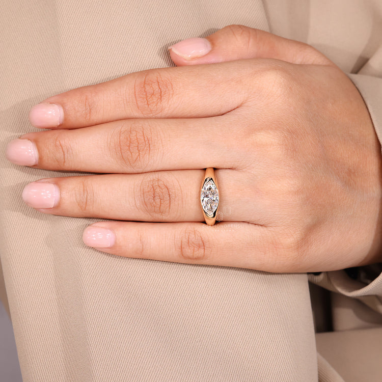Solitaire style marquise diamond engagement ring.