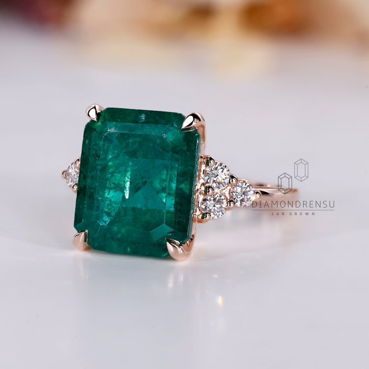 Emerald ring seven stone muse tapered shank style.
