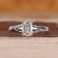 Emerald cut diamond ring pave band split shank prong set.