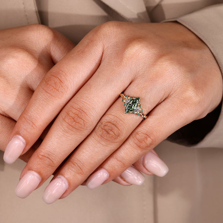 Marquise ring green emerald and trillion side stones.
