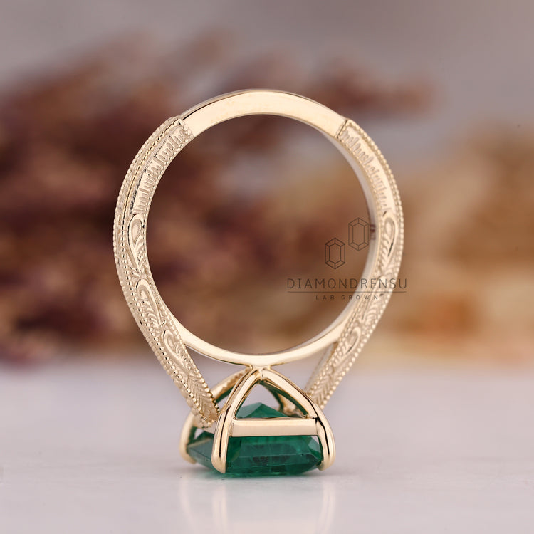Emerald gemstone ring milgrain tapered shank style.