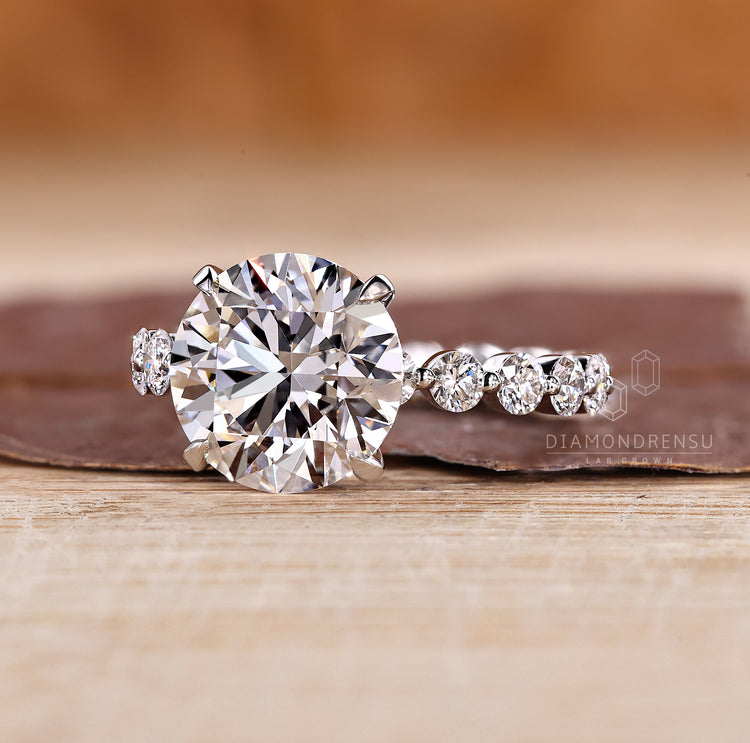 Blue oval diamond ring with heart shape side stones.