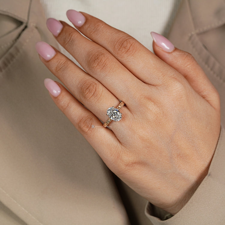 Oval diamond ring with vintage milgrain details.
