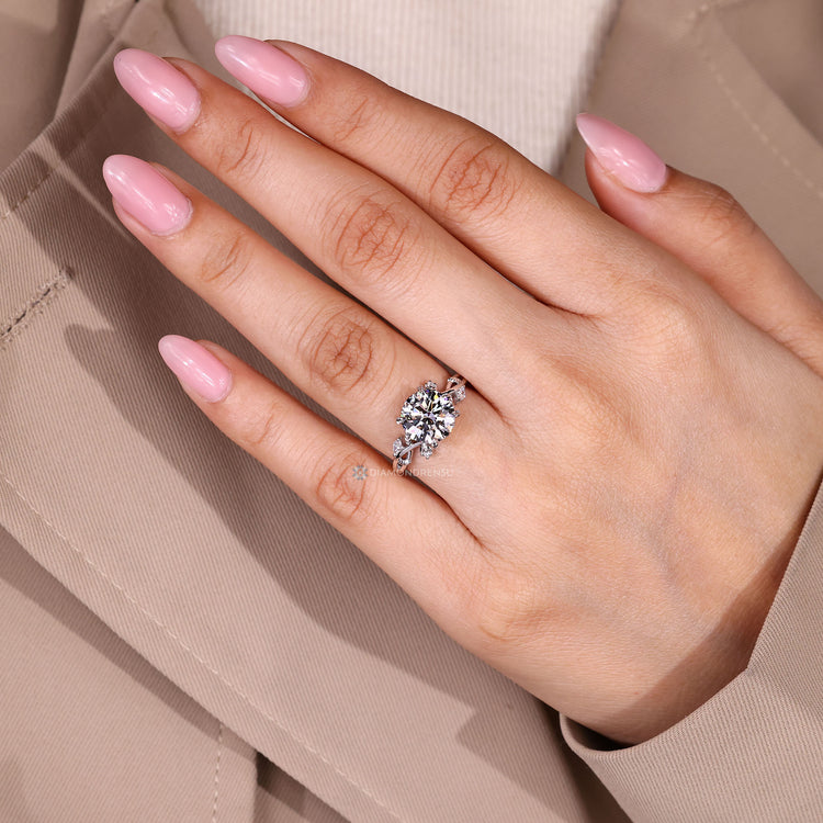 Lab grown round diamond ring with leaf prongs.