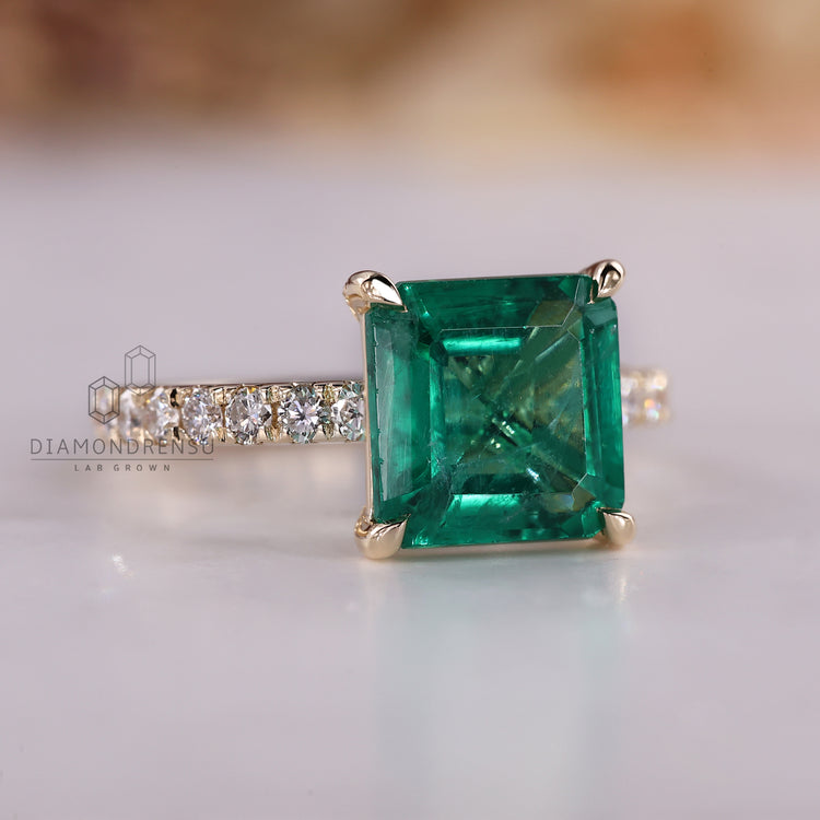 Emerald gemstone ring Asscher cut pave prong style.