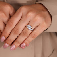Round cut diamond ring four prong halo style.