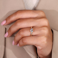 Heart cut diamond ring with round diamonds.