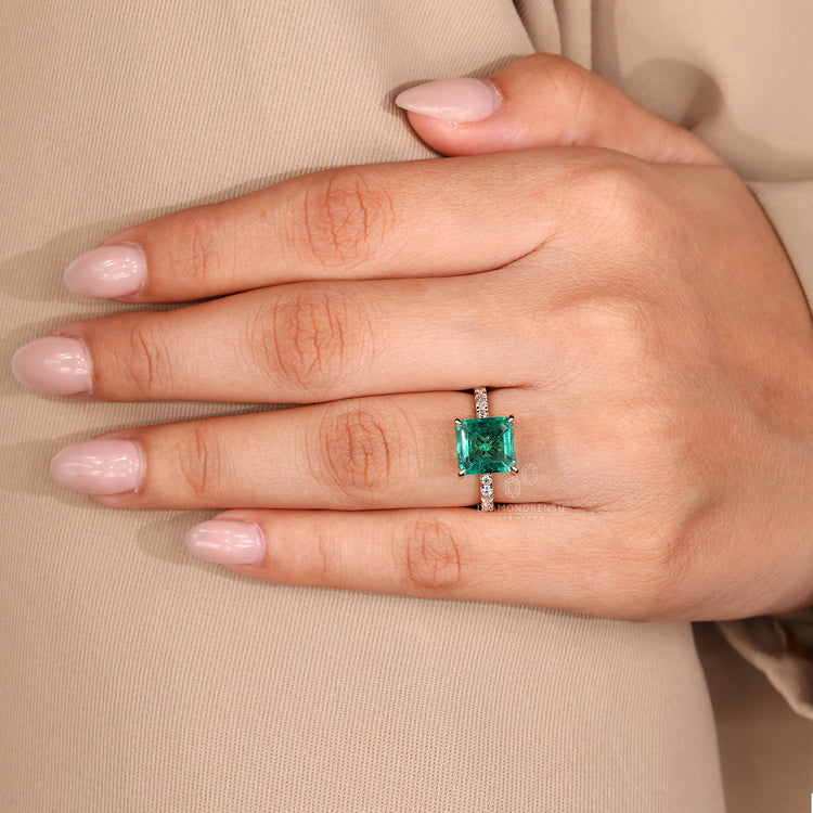 Emerald gemstone ring pave band prong set style.
