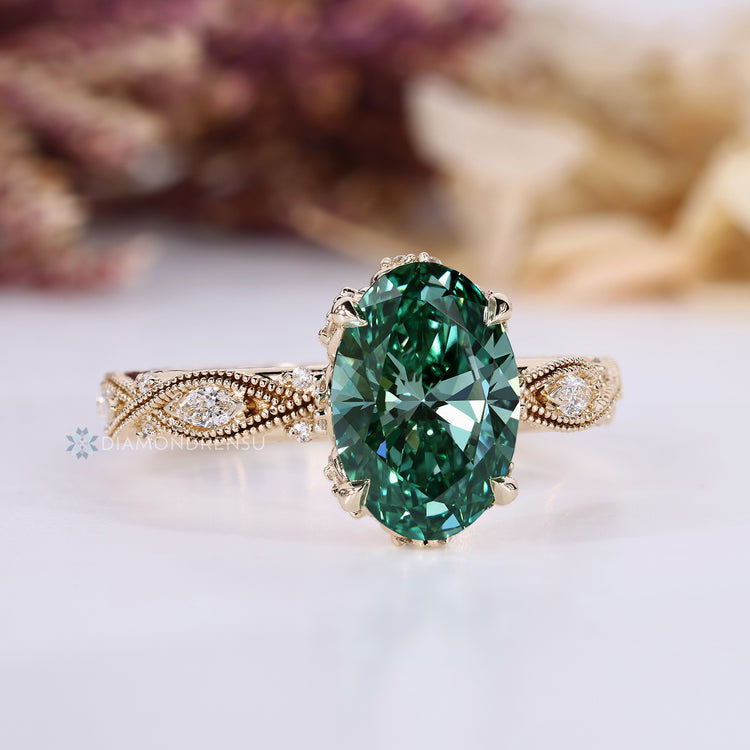 Vintage oval ring with green diamond and side stones.