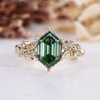 Hexagon diamond ring with green diamond.