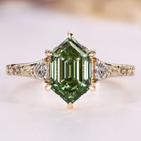 Hexagon diamond ring with trillion cut side stones.