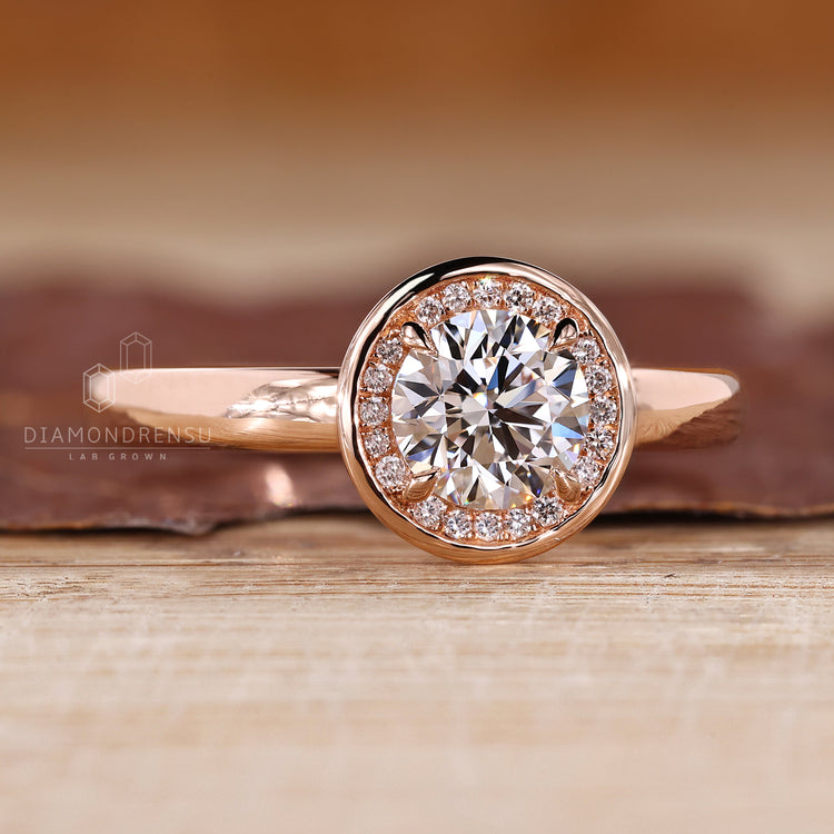 Halo round diamond ring bezel four prong setting.