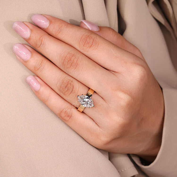 Elegant solitaire diamond ring with C prong setting.