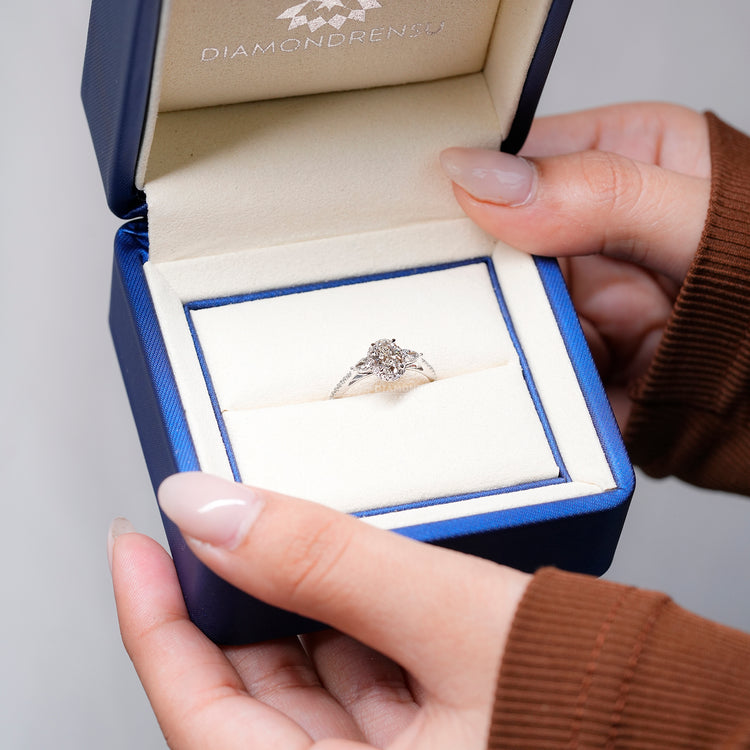 Lab grown oval diamond ring with pear side stones.