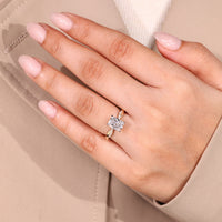 Radiant cut diamond ring with four claw prong setting.