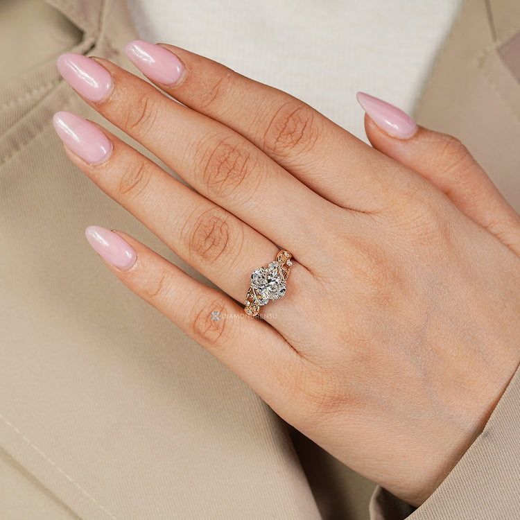 Oval diamond ring leaf detailing and side stones.