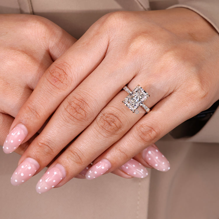 Radiant cut diamond ring with tapered pave shank.