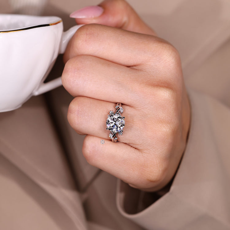Round diamond ring with leaf style prong setting.