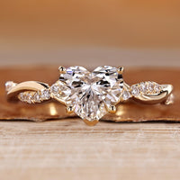 Heart cut diamond ring with twisted pave style.