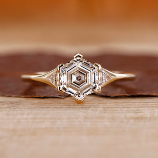 Hexagon step cut diamond ring triangle side stones.