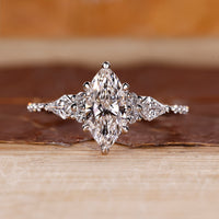 Marquise diamond ring kite round side stones muse set.