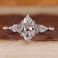 Marquise diamond ring kite round side stones muse set.