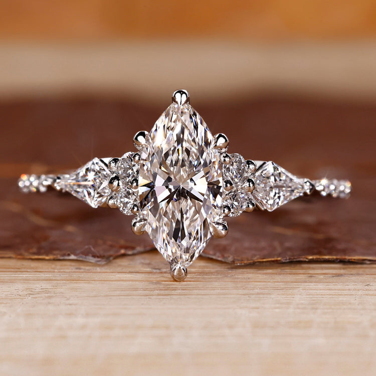 Marquise diamond ring kite round side stones muse set.